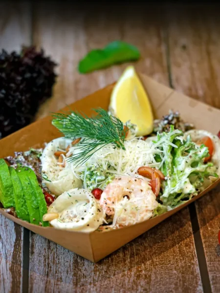 shrimp pasta salad recipe for summer with shell pasta, pink shrimp, cucumber, and dill in lemon mayo served in a white bowl
