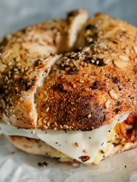 skinny bagel recipe with golden baked Greek yogurt bagels topped with everything seasoning on a parchment lined tray