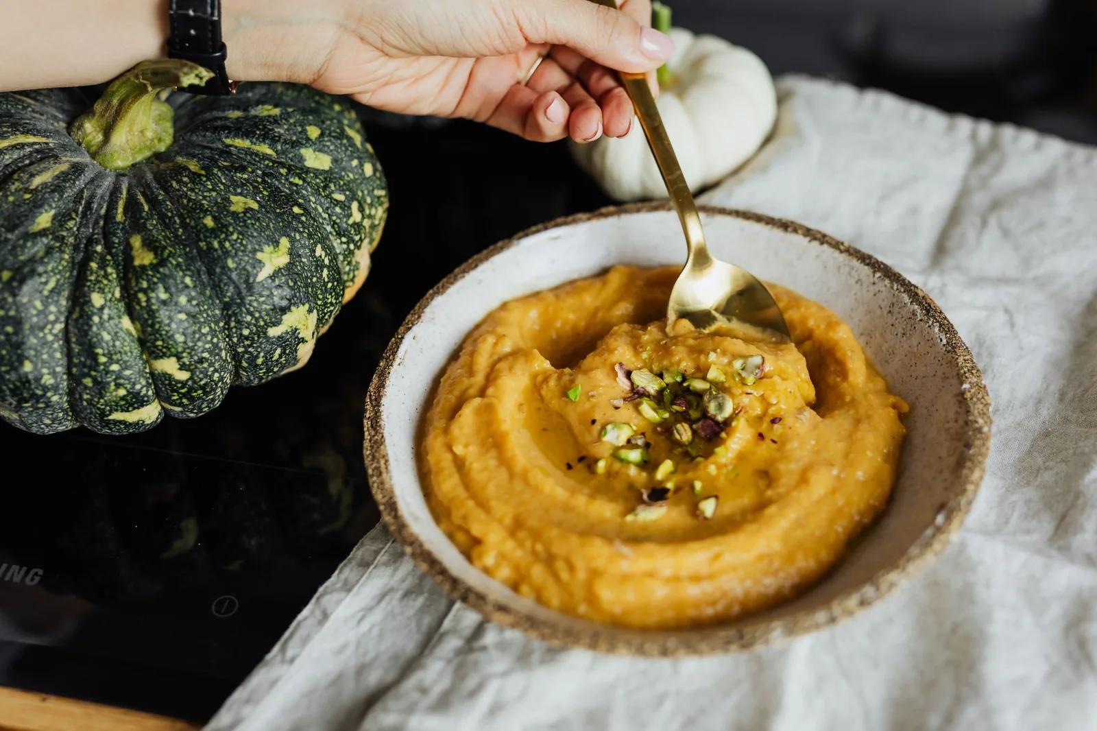bowl of slow cooker pumpkin and sweet potato soup with cream