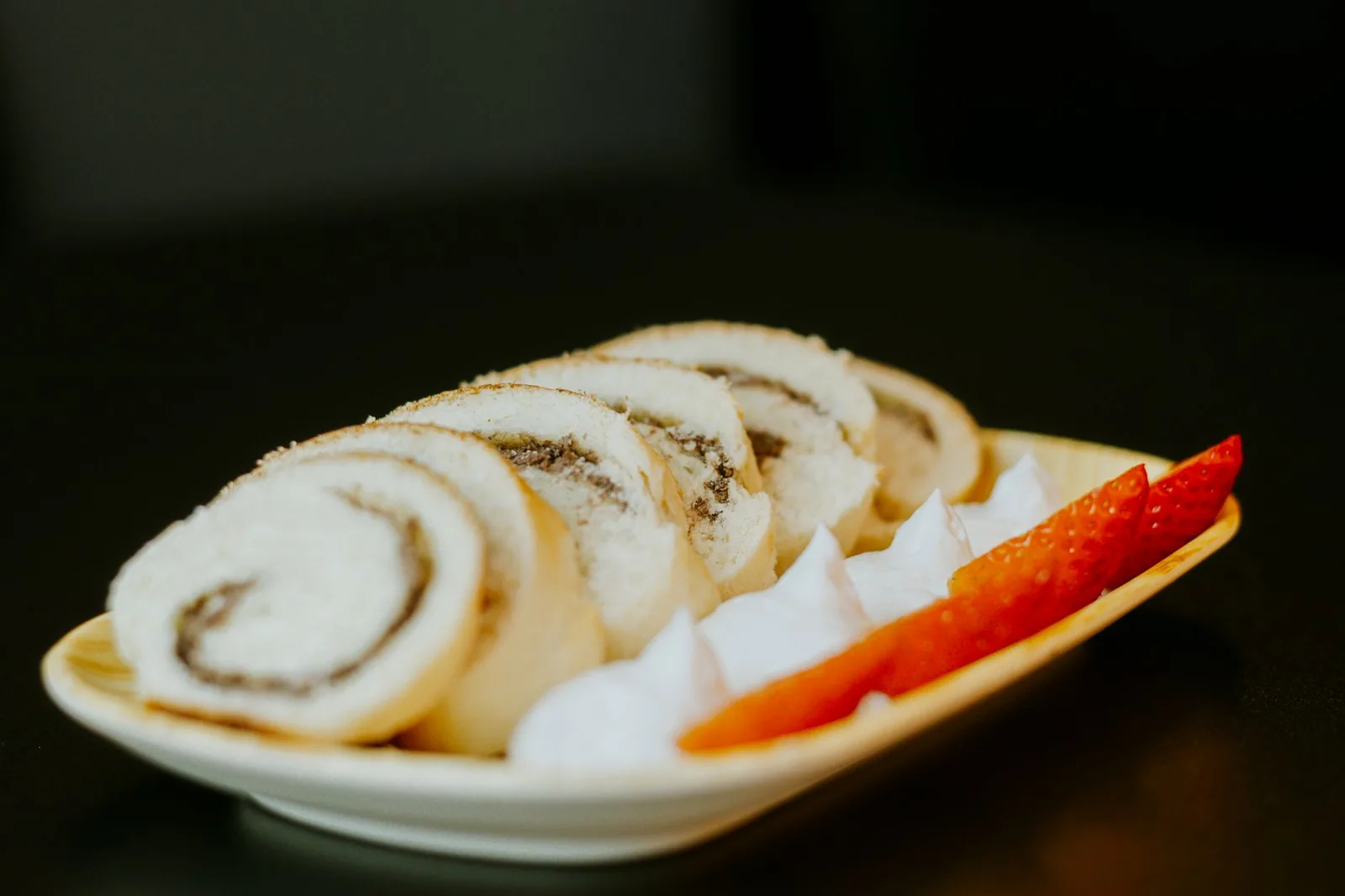 strawberry french toast roll ups on a plate with cinnamon sugar